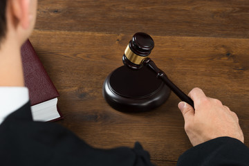 Judge Hitting Mallet In Courtroom © Andrey Popov