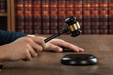Judge Hitting Gavel At Desk