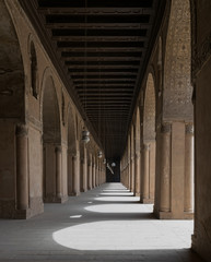Obraz premium Corridor of a historic mosque with arches and wooden ceiling
