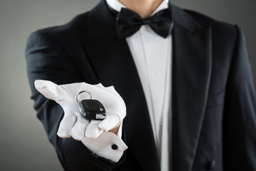 Midsection Of Waiter Holding Car Key