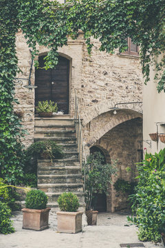 Street decorated with plants and flowers in the historic Italian city of Spello (Umbria, Italy)
