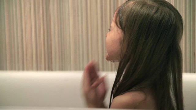 Little girl bathes play in a bath