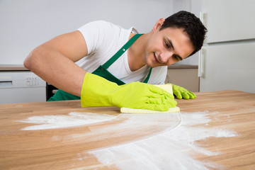 Cleaner Cleaning Dust On Wooden Table