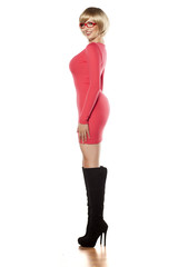 side view of attractive blonde in a tight red dress and boots