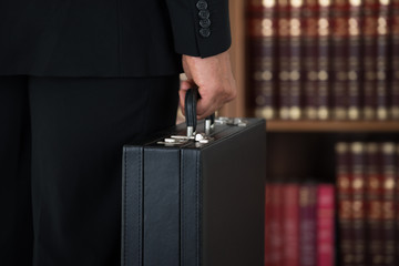 Businessman Carrying Briefcase In Office