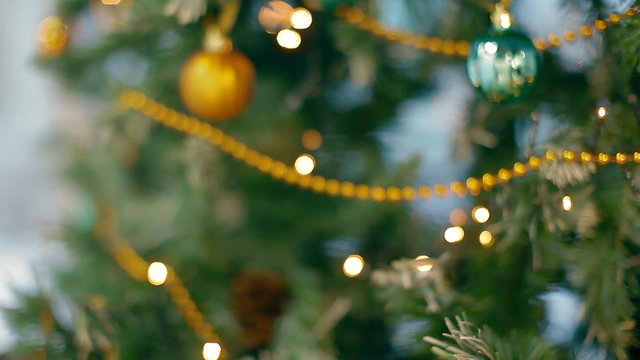 Christmas tree in blur with garlands and balls
