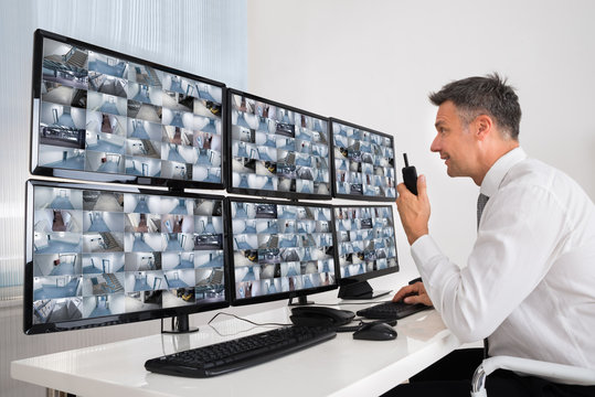 Security System Operator Looking At CCTV Footage