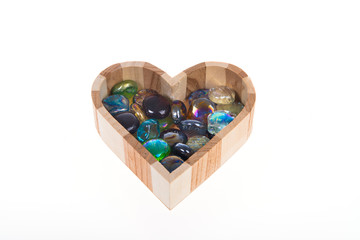 Wooden casket in the form of heart with colored stones