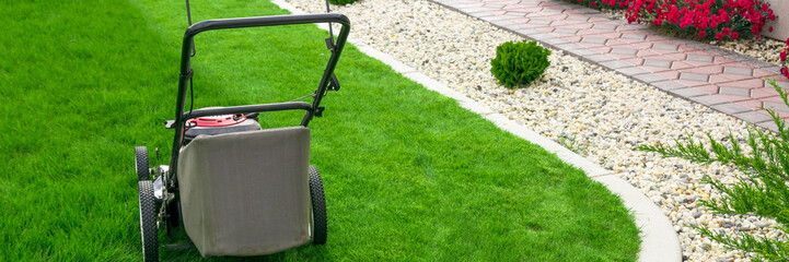 Fototapeta na wymiar Lawn mower on green grass