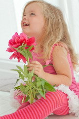 Happy little girl with a flowers bouquet 