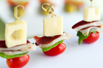 Appetizing mini duck ham skewer with cheese.