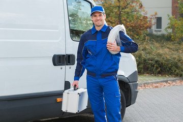 Confident Electrician With Cable Coil And Toolbox