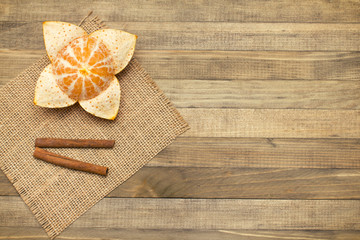 two stick cinnamon and mandarin fruit on wooden background
