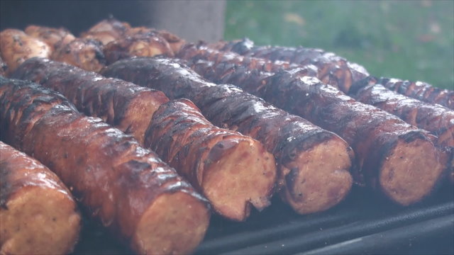 Close up of cut polish sausages on the fire pit's grill 3
