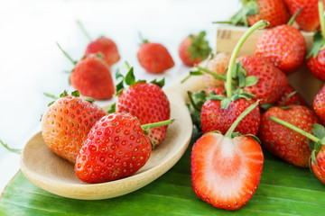 fresh strawberry in heap on banana leaves