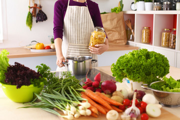 Young Woman Cooking in the kitchen. Healthy Food