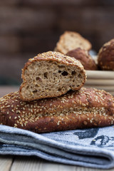 Protein bread (without flour) with linseeds, sunflower seeds and sesame seeds in wooden bowl. Selective focus. Natural light.