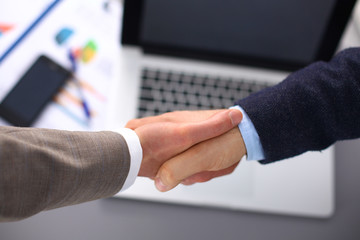 Business handshake. Two businessman shaking hands with each other in the office