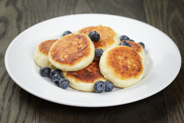 sirniki traditional russian pancakes from cottage cheese with blueberries