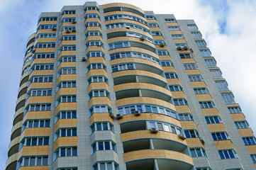 Fototapeta na wymiar High rise building with yellow balconies.