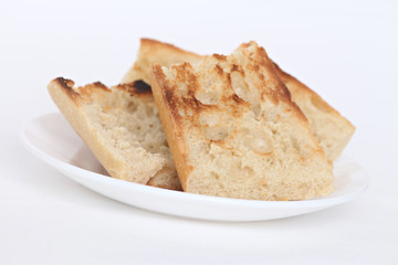 close up of pieces of toast on a white plate