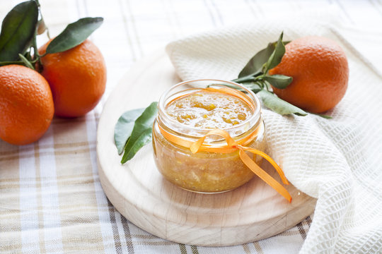Orange jam in glass jar, selective focus.