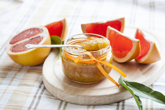 Orange jam in glass jar, selective focus.