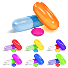 Set of oblong and elliptical multicolored capsules and round pills with shadows on white background