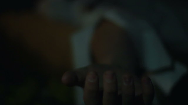 Hand of injured person on ground, man dying of suffocation, killer's victim