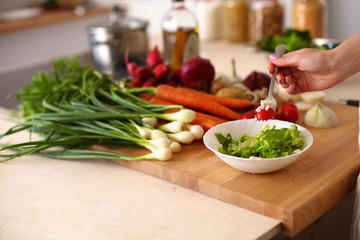 Young Woman Cooking in the kitchen. Healthy Food