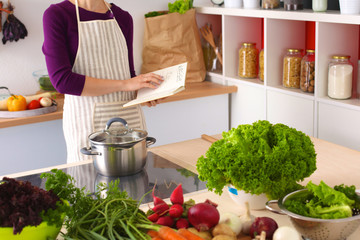 Young Woman Cooking in the kitchen. Healthy Food