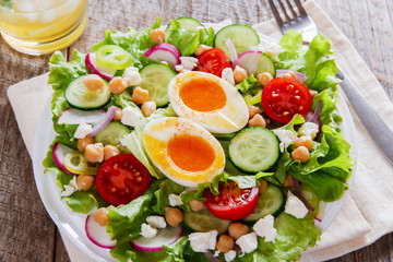 salad with egg tomato cucumber chickpeas cheese