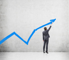 Businessman painting a graph