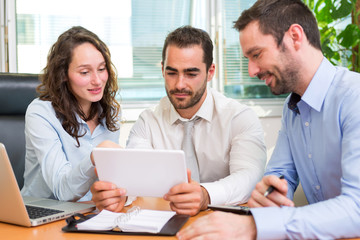 Group of business associates working together at the office