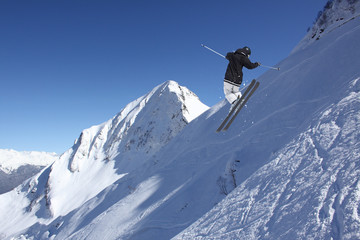Naklejka na ściany i meble Flying skier on mountains. Extreme sport.