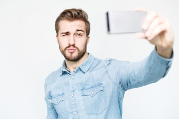 Handsome Man takes a Selfie with Smartphone