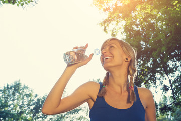 Jogger drinking water after hard exercise.