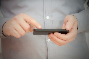 Texting on a smartphone. Shallow depth of field.