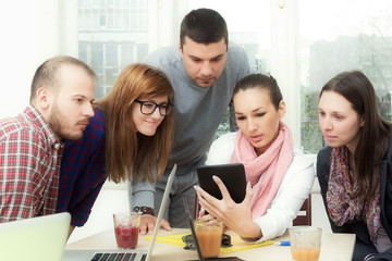 Young group of people discussing business plans.