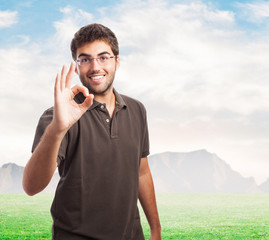 handsome young caucasian man doing a success symbol