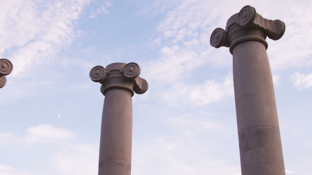 Low-angle slow pan of ionic columns