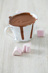 hot chocolate and heart-shaped marshmallow on wooden table