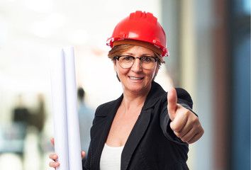 portrait of a mature architect woman holding a plane