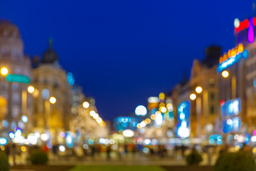 Obraz premium Out-of-focus shimmering city background, blurred bokeh photo of Wenceslas Square at night, Prague, Czech Republic. 