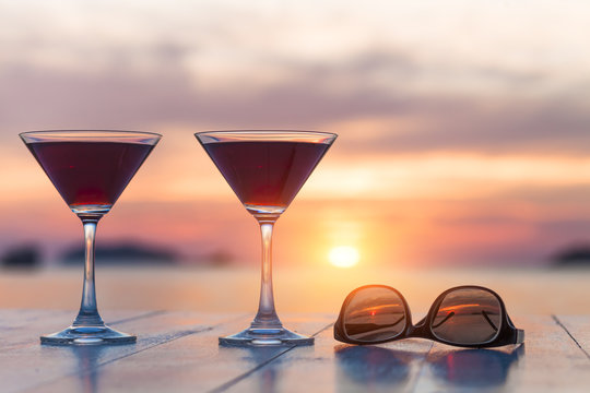 Two cocktails and sunglasses at a beach restaurant, honeymoon, s