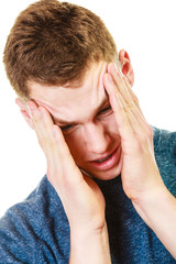 Fototapeta premium Closeup stressed man holds head with hands