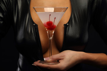 Woman holding cocktail with cherry - 100235437