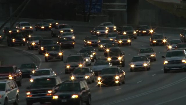 Static shot of traffic on the freeway while the sun barely lights the scene in Atlanta, Georgia.
