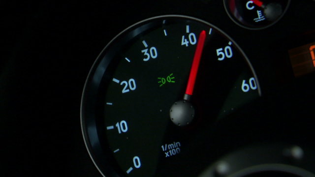 Close up of an RPM dial revving up.