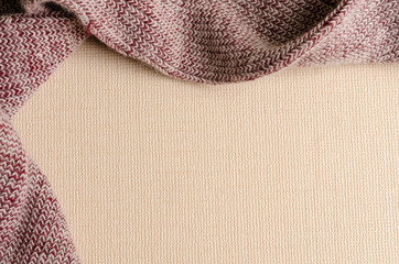 Empty beige paper background with red wool